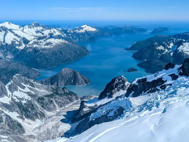 A thin bay surrounded by mountains and ice